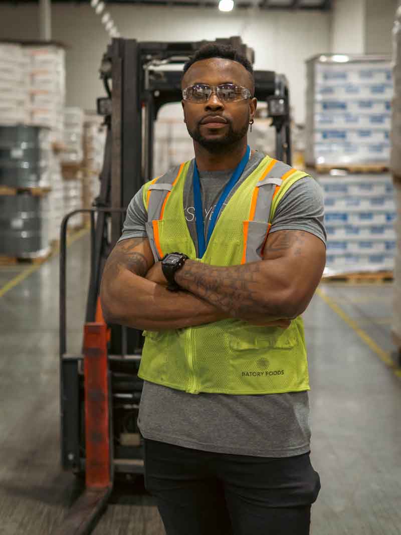 Batory Foods warehouse employee standing in a distribution facility.